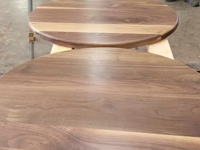 Row of finished round walnut tabletops with hand-rubbed oil finish in Estacada, OR — Devine Home Remodeling & Construction