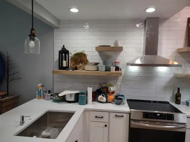 Remodeled kitchen featuring undermount sink, quartz waterfall counters, and pendant lighting near Estacada, OR — Devine Home Remodeling & Construction