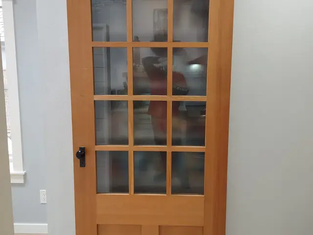 Custom 15-lite fir sliding barn door installed off the remodeled kitchen near Estacada, OR — Devine Home Remodeling & Construction
