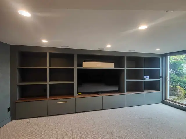 Finished gray built-in entertainment cabinetry with walnut counters near Estacada, OR — Devine Home Remodeling & Construction