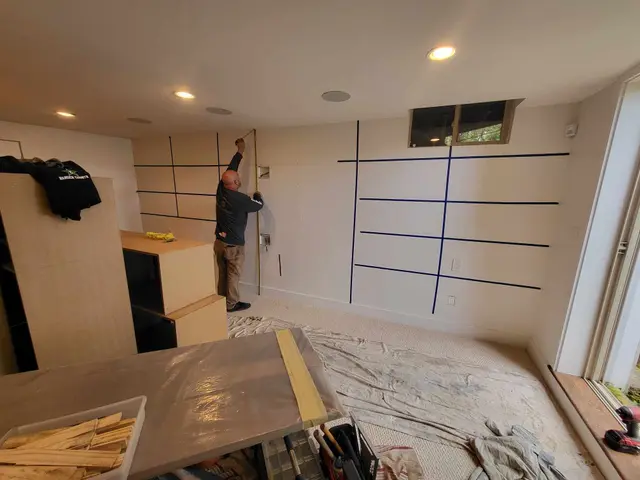 Tape layout mock-up for a wall-spanning built-in entertainment center near Estacada, OR — Devine Home Remodeling & Construction